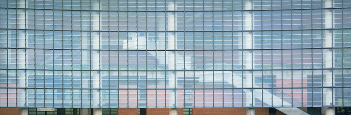 abstract pattern structure of steel decoration with light transparent glass wall texture window panel brick.modern industrial new style smart office building save energy architecture facade exterior.