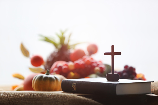 Church Thanksgiving Day bountiful fruit decoration and background with bible and jesus cross