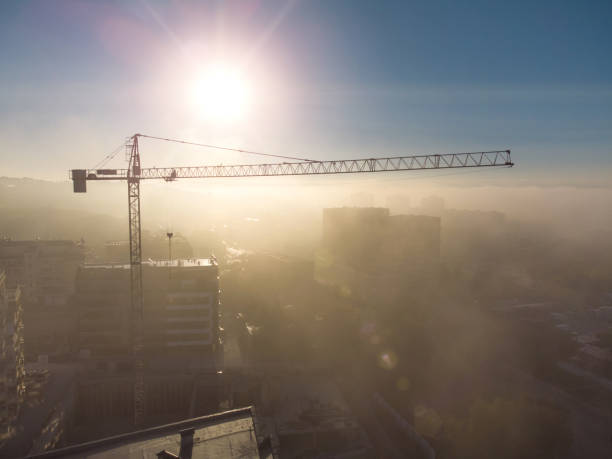 istock tower cranes on a construcion site with dense fog aerial view 1435054462