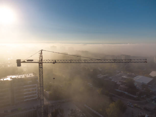 istock tower cranes on a construcion site with dense fog aerial view 1435054468