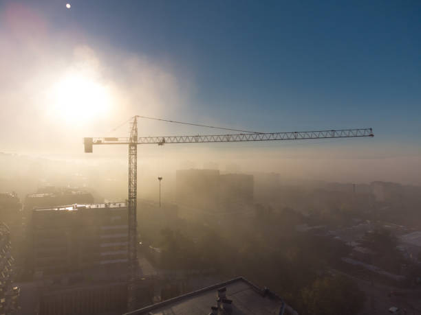 istock tower cranes on a construcion site with dense fog aerial view 1435054471
