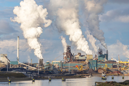 Steel plant at IJmuiden on the north coast of the Netherlands with clouds of Cardon Dioxide coming out of towers from the combustion of natural gas. Tata Steel’s IJmuiden plant is one of the world leaders in the production of low emission steelmaking.