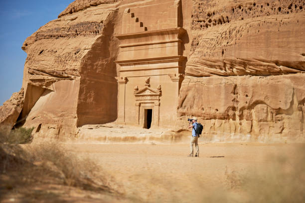 istock Photographer working around sandstone rock-cut tombs, Hegra 1435058752