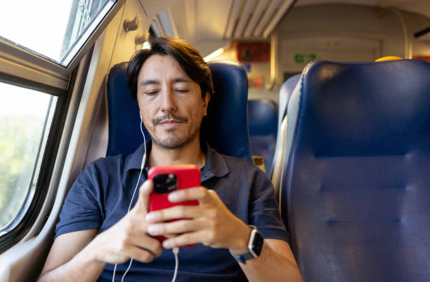 istock Man riding on the train and texting his cell phone 1435059466