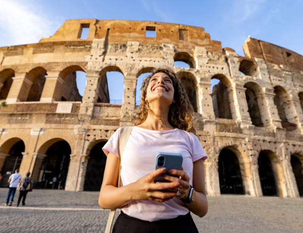 Happy tourist in Rome visiting the Coliseum