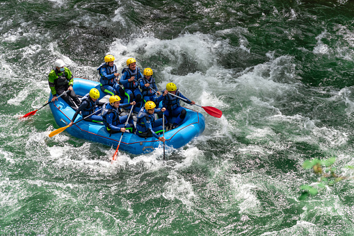 Llavorsí - Lleida - Espanha - June 21, 2021: Groups of young friends having fun rafting on the rapids of the river