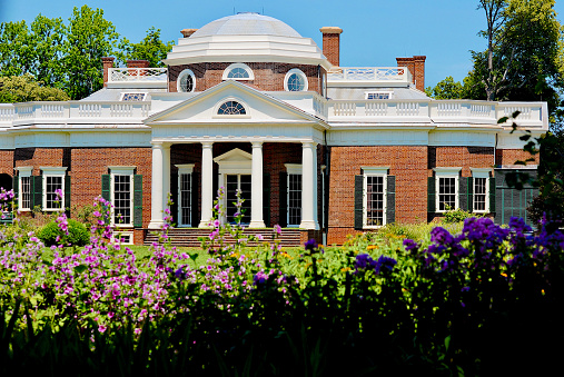 Charlottesville, Virginia, USA - June 17, 2012: Flowers frame Thomas Jefferson’s home, Monticello, on a bright sunny day.