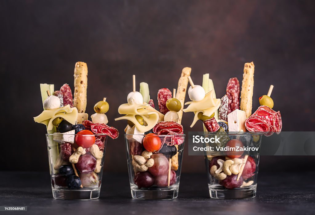 Jarcuterie in a glass, the modern version of charcuterie. includes various types of sausages, pickles and cheese Jarcuterie in a glass, the modern version of charcuterie. includes various types of sausages, pickles and cheese. High quality photo Charcuterie Stock Photo