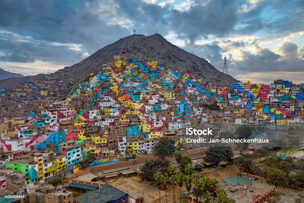 Shanty town in Lima, Peru. The once gray houses of the impoverished district of the Peruvian capital Lima shine in all colors. The campaign aims to attract tourists and improve the lives of residents. Lima - Peru Stock Photo