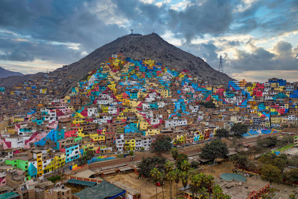 Shanty town in Lima, Peru. The once gray houses of the impoverished district of the Peruvian capital Lima shine in all colors. The campaign aims to attract tourists and improve the lives of residents. stock photo