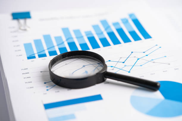 istock Magnifying glass on charts graphs paper. Financial development, Banking Account, Statistics, Investment Analytic research data economy, Stock exchange trading, Business office company meeting concept. 1435069324