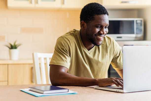 istock latin hispanic man freelancer using laptop studying online working from home 1435069338