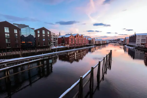 Winter in Trondheim, view of the river Nidelva and timber historical old buildings ( bryggeri)  along the river