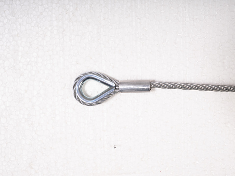 Metal loop with steel wire on white background.
