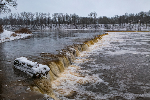 Winter landscape. Venta Rapid (Ventas rumba), waterfall on the Venta River in Kuldiga, Latvia. Widest waterfall in Europe.