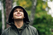 Portrait of a cute teenage boy hiker on a rainy autumn day