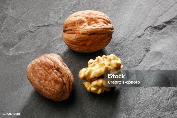 Walnuts On The Gray Granite Stone Background Stock Photo - Download Image Now - Close-up, Color Image, Cracked