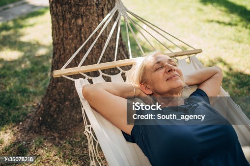 istock Woman sleeping in hammock 1435078218