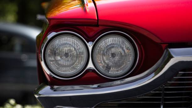 istock Closeup of a red Ford Thunderbird car silver headlights with blurred background 1435078435