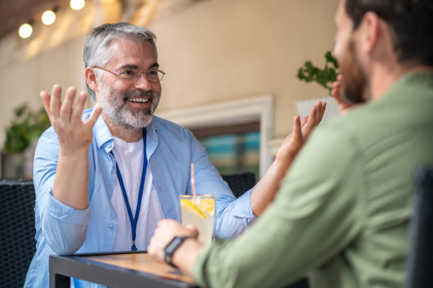 istock Two men sitting in the cafe and having an interesting conversation 1435078612