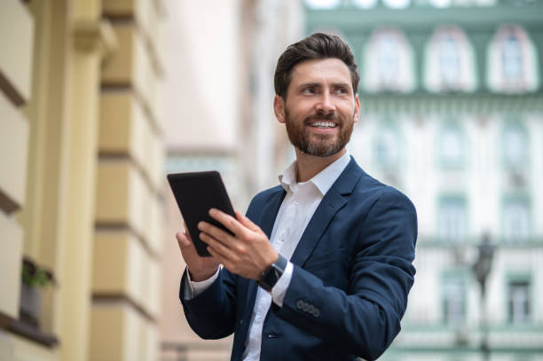 istock Young businessman with a tablet in hands having a video call 1435078637