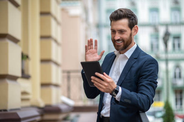istock Young businessman with a tablet in hands having a video call 1435078642