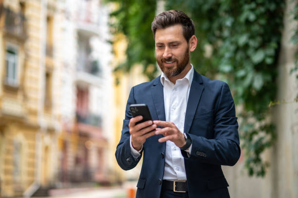 istock Elegant young businessman with a phone in hands 1435078709