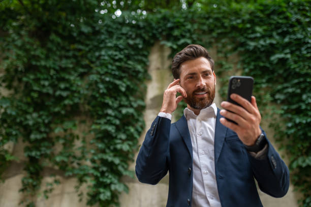istock Good-looking handsome man with a phone in hand 1435078721