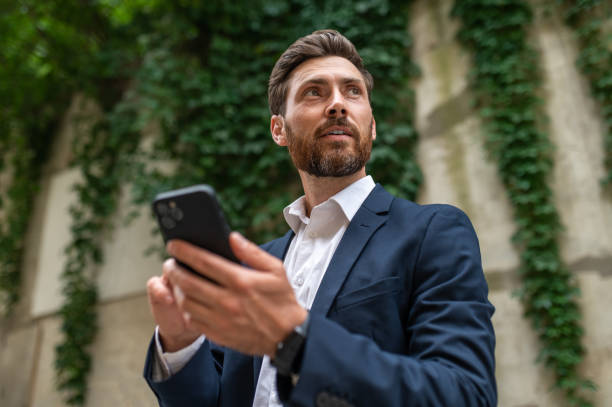 istock Good-looking handsome man with a phone in hand 1435078729