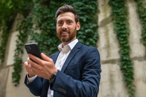 istock Good-looking handsome man with a phone in hand 1435078733