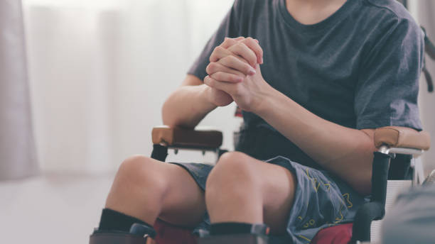 istock Alone boy praying on wheelchair. 1435079924