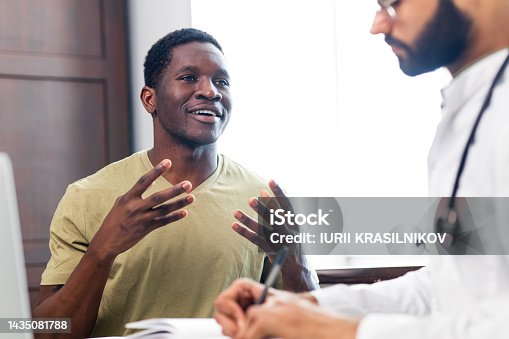 istock doctor and male patient talking at office consultation for further treatment 1435081788