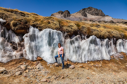 A tourist stands in front of the Jaruma Ice Walls, located exactly on the route between Arequipa and Chivay.