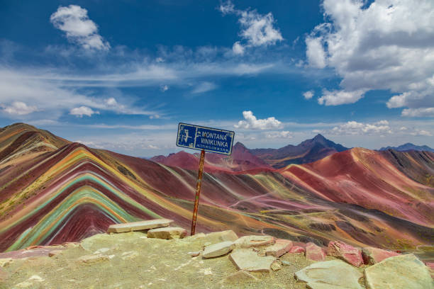 On the top of the Rainbow Mountains stands the sign with the height and name of the mountain: Vinicunca stock photo
