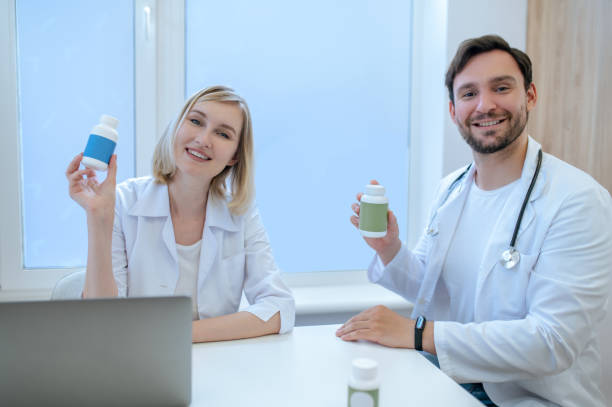 istock Smiling friendly dietitians demonstrating dietary supplements before the camera 1435082098
