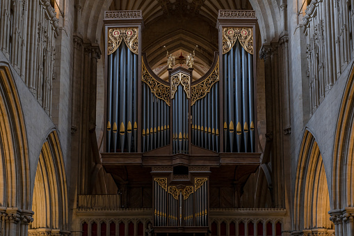 Wells, United Kingdom - 1 September, 2022: close-up view of the church organ and pipes inside the historic Wells Cathedral