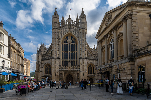 Bath, United Kingdom - 31 August, 2022: downtown Bath with the catehdral and many tourists