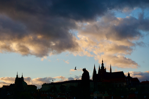 Sunset silhouettes of Prague from the Charles Bridge.