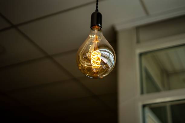 istock Closeup of a bulb hanging from a ceiling 1435087930