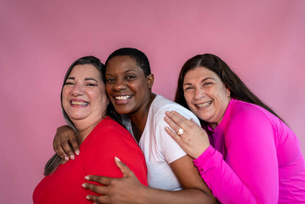 istock Happy mature friends together on a pink background 1435089355