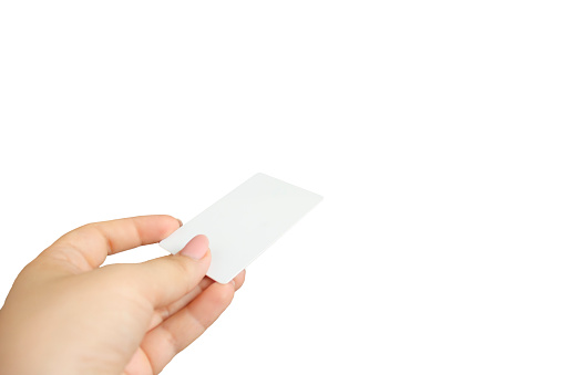 Female hand holding business card isolated on white background.