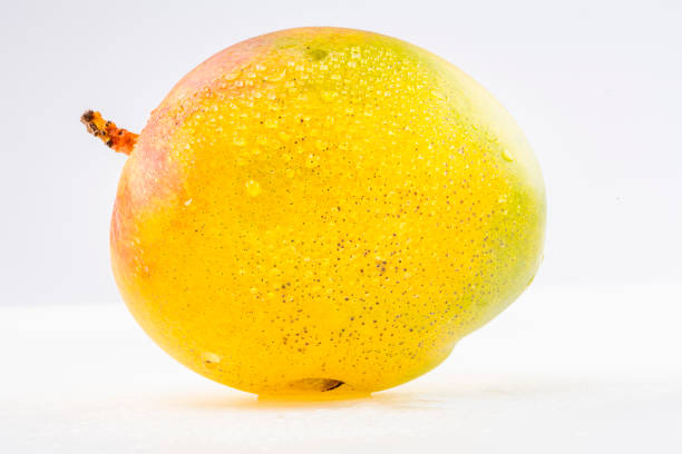 Ripe mango close-up on white background