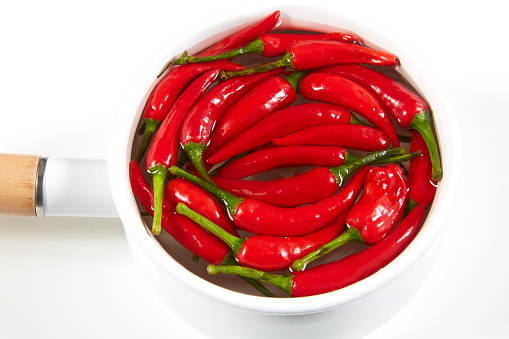 Fresh hot chili pepper in a white pot