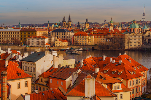 Panoramic cityscape image of famous Charles Bridge in Prague during beautiful autumn sunset.