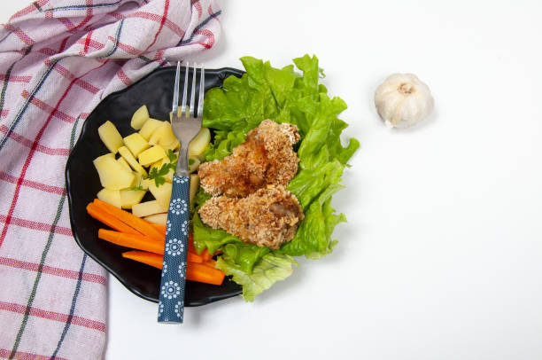Beautiful salad dish with potato, carrot, lettuce and breaded chicken delicious salad dish with potato, carrot, lettuce and breaded chicken caesar grunt photos stock pictures, royalty-free photos & images