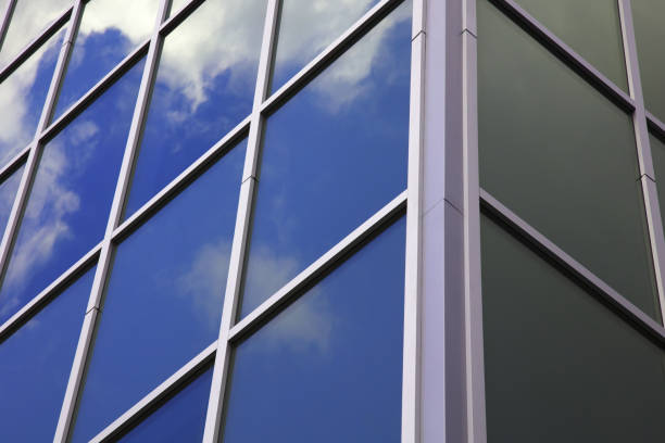 istock office building glass windows skyscraper corner workplace blue sky clouds graphic reflections 1435093695