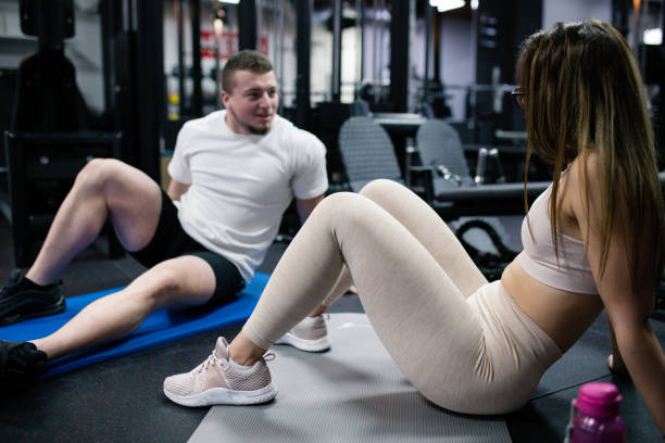 istock Couple taking a break and talking in a gym 1435095129