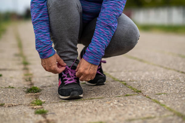 istock Grandma ties shoelaces 1435095300