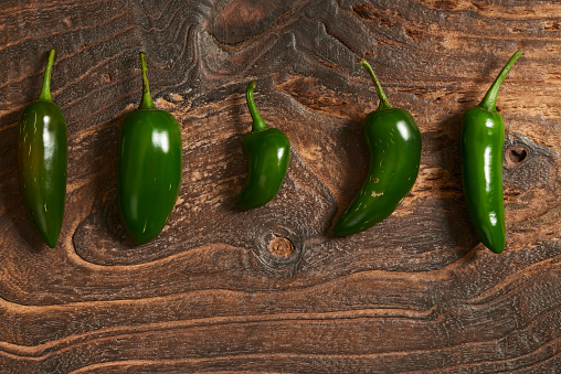 Fresh green Mexico Jalapeno Pepper on Wooden background.