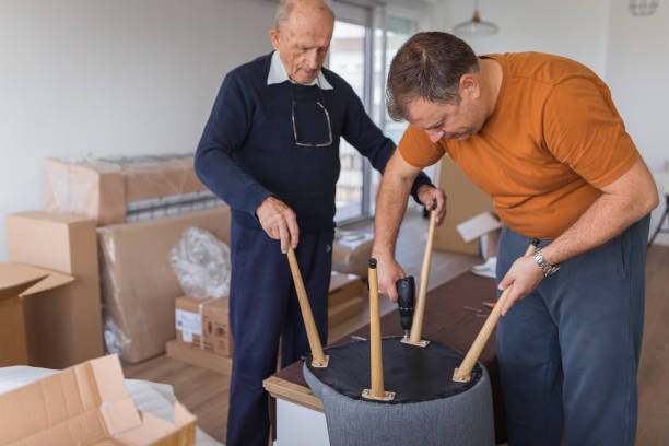 istock Senior man assembling a chair and having his son help him with a drill 1435099520